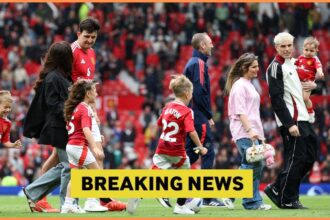 Manchester United players on the pitch with their families