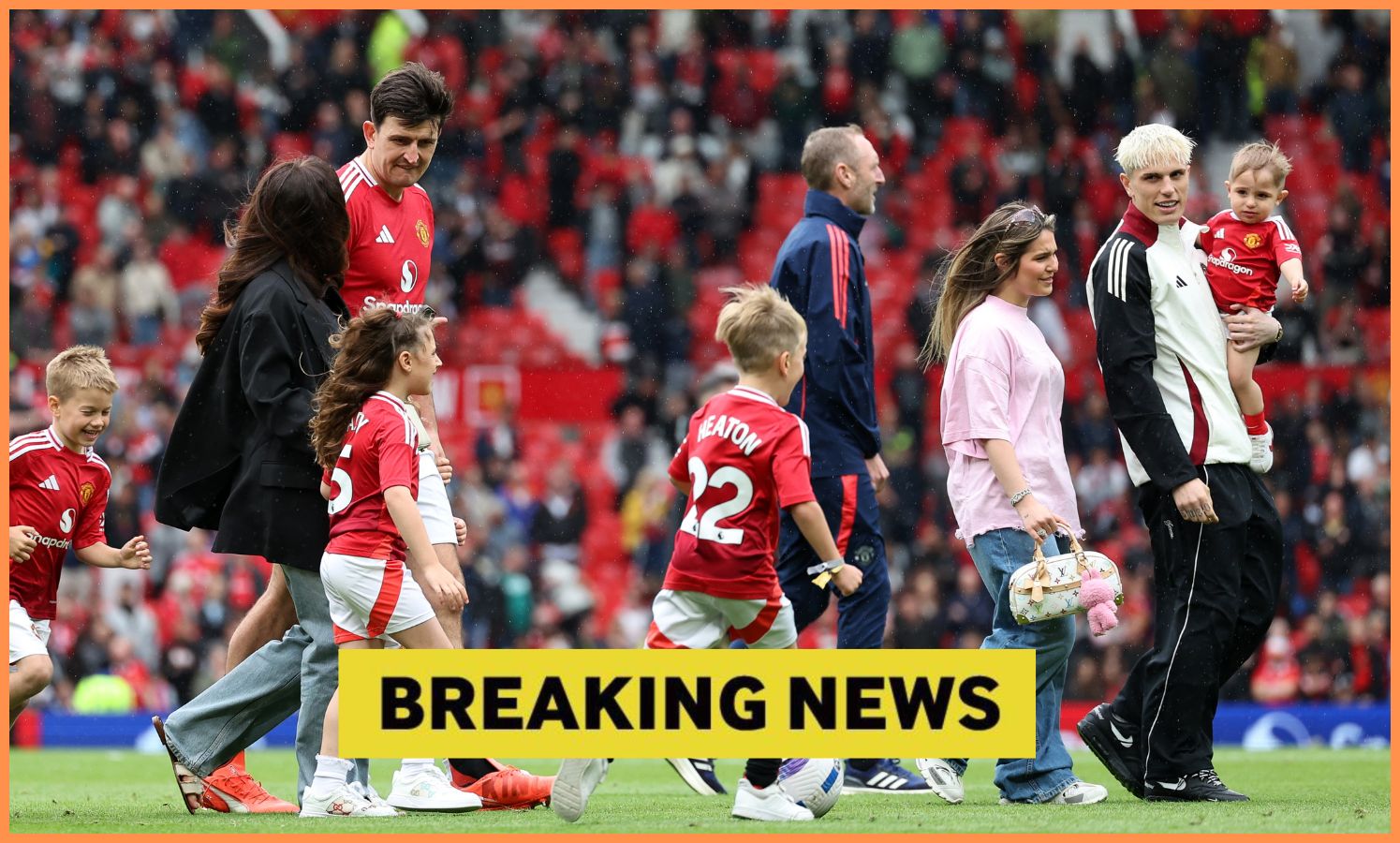 Manchester United players on the pitch with their families