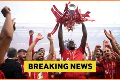 Ibrahima Konate lifts the Premier League trophy with Liverpool