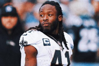 Alvin Kamara interacts after Wild's first pitch before the Cardinals Cubs game