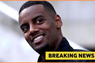 Close-up of Alexander Isak smiling, plus yellow