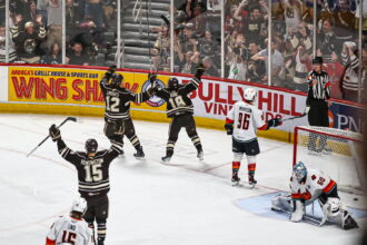 Former Hershey holds the Russian Pierric Duve sign forward