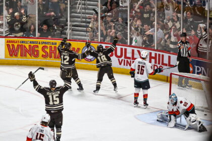 Former Hershey holds the Russian Pierric Duve sign forward