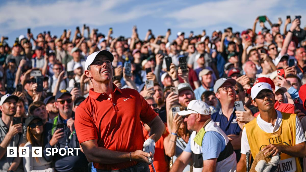 The gallery watches on as Rory McIlroy hits his approach into the 17th