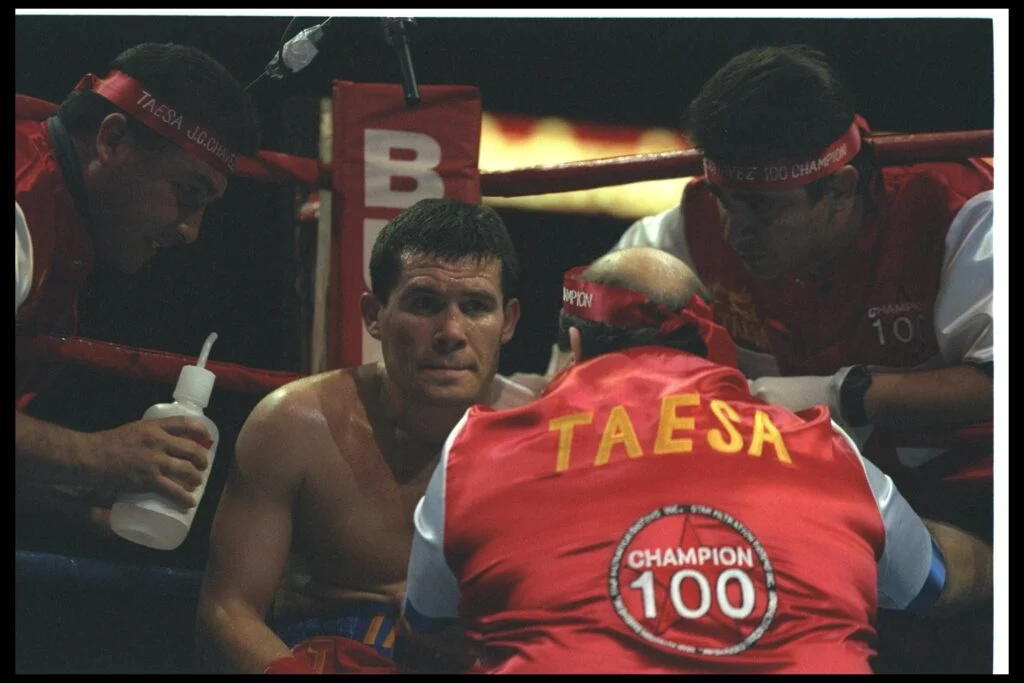 Julio Cesar Chavez was sitting in a chair in the corner.