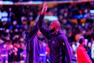Los Angeles Lakers forward LeBron James (23) high-fives Los Angeles Lakers guard Luka Doncic (77) after the national anthem before the game against the Utah Jazz at Crypto.com Arena in Los Angeles, California on November 18, 2025.