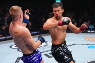 Shavkat Rakhmonov unleashes a spinning attack on Ian Machado-Galley during their fight at UFC 310