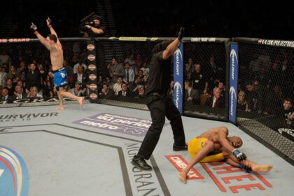 Chris Weidman celebrates as Anderson Silva holds his leg in pain at UFC 168