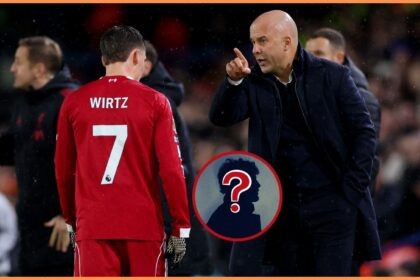 Florian Wirtz and Arne Slot talk on the touchline during Leeds vs Liverpool