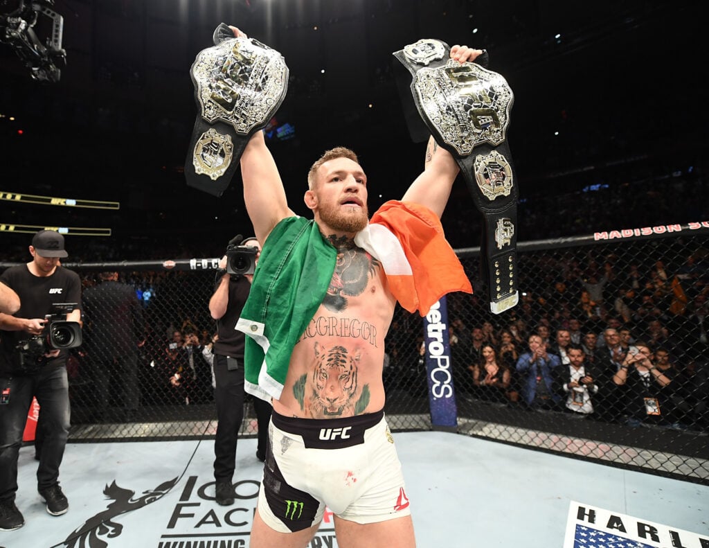 Conor McGregor celebrates winning both belts at UFC 205