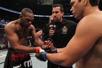 Jon Jones and Lyoto Machida touch gloves during the main event of UFC 140