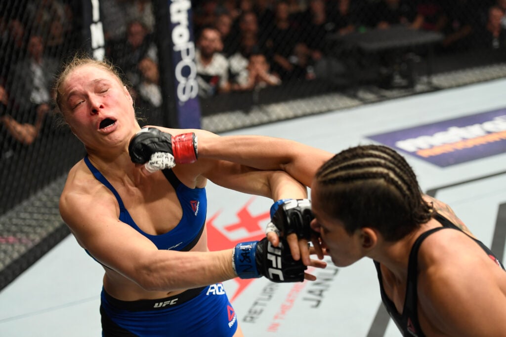 Amanda Nunes punches Ronda Rousey in their UFC 207 title fight