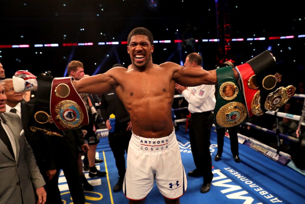 Anthony Joshua celebrates in the ring after his heavyweight title fight against Alexander Povetkin in September 2018.