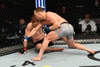 Michael Chandler punches Dan Hooker at UFC 257