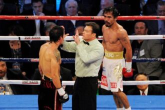 Referee standing between Manny Pacquiao and Antonio Margarito in WBC super welterweight title fight