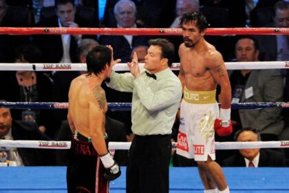 Referee standing between Manny Pacquiao and Antonio Margarito in WBC super welterweight title fight