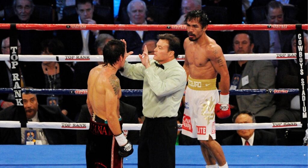 Referee standing between Manny Pacquiao and Antonio Margarito in WBC super welterweight title fight