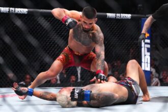 Ilya Topria lands a KO punch against Charles Oliveira in the UFC