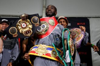 Terrence Crawford poses with his undisputed super middleweight title