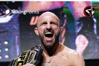 Alexander Volkanovski poses on stage during the UFC 325 press conference