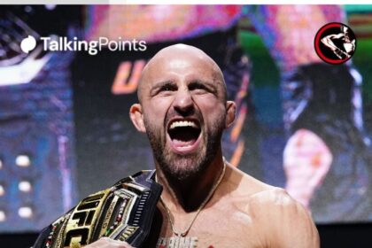 Alexander Volkanovski poses on stage during the UFC 325 press conference