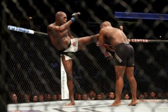 Jon Jones kicks Daniel Cormier in the head in UFC 214 rematch