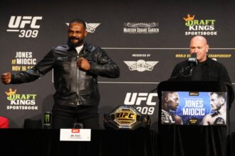 Jon Jones thanks the crowd with UFC CEO Dana White at the UFC 309 press conference