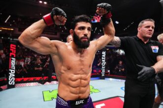 Arman Tsarukyan raises his hand after winning at UFC Qatar