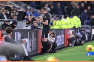 Referee checking the VAR screen during a Premier League match