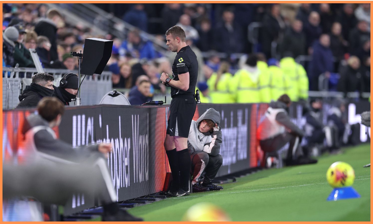 Referee checking the VAR screen during a Premier League match