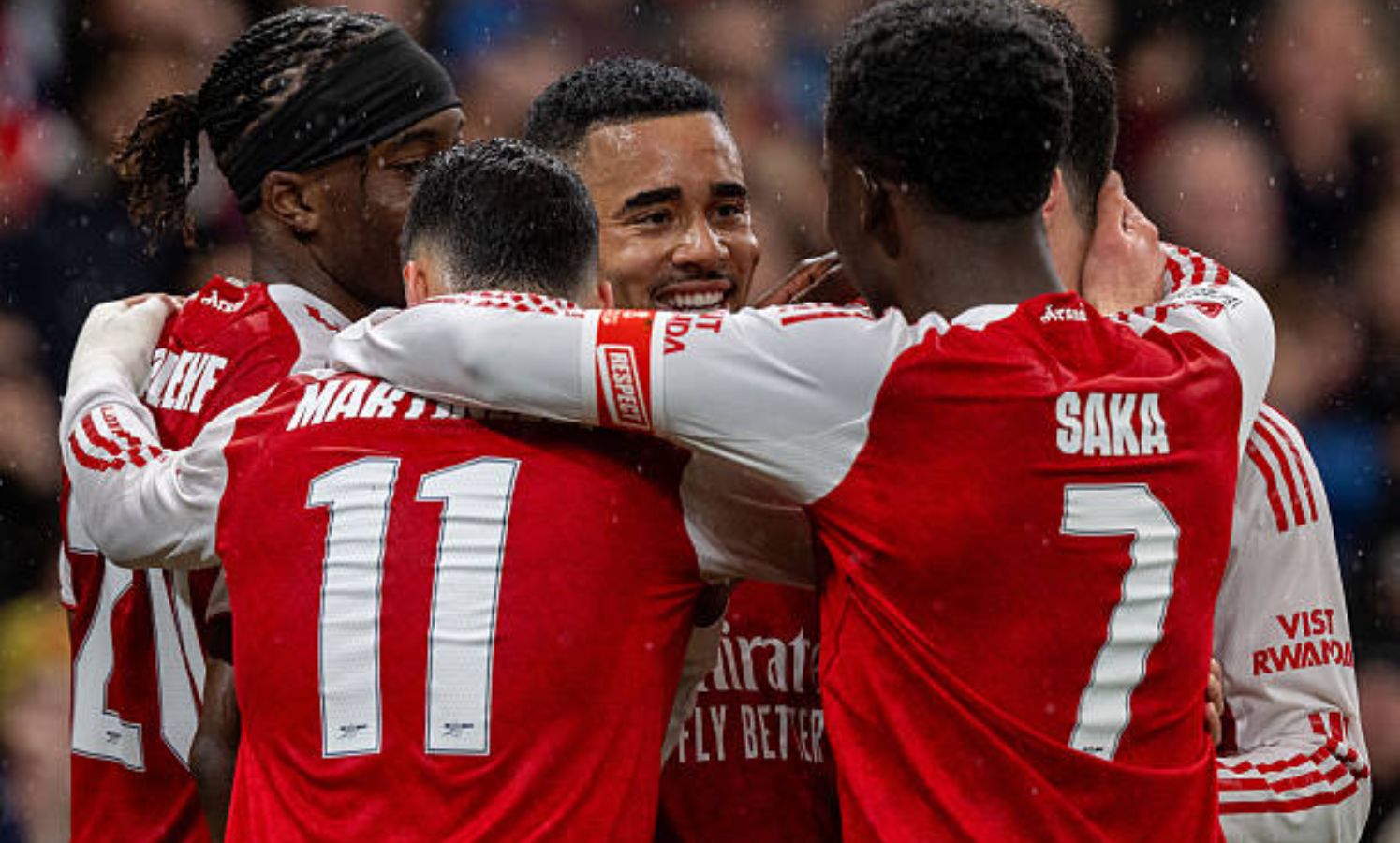 Arsenal players celebrating goal vs Wigan