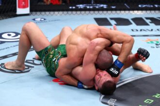 Khamzat Chimaev slams Dricus du Plessis to the ground in their title fight at UFC 319