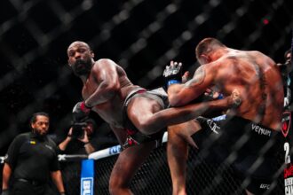 Jon Jones hits Stipe Miocic with a spinning body kick at UFC 309