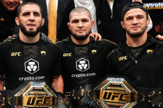 Islam Makhachev, Khabib Nurmagomedov and Usman Nurmagomedov retain Islam's two UFC title belts in the Octagon after the fight
