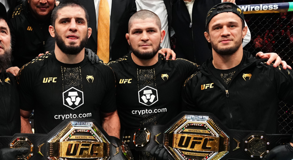 Islam Makhachev, Khabib Nurmagomedov and Usman Nurmagomedov retain Islam's two UFC title belts in the Octagon after the fight