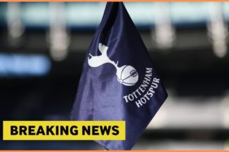 Tottenham Hotspur logo on corner flag, and breaking news banner
