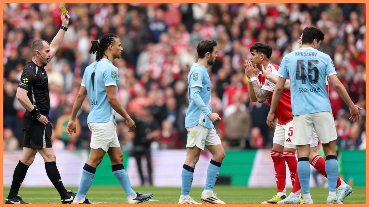Referee Peter Bankes shows a yellow card to Piero Hincapie of Arsenal during the Carabao Cup Final match Arsenal and between Manchester City at Wembley Stadium