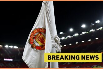 Manchester United logo on corner flag and breaking news banner