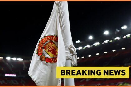 Manchester United logo on corner flag and breaking news banner