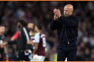 Arne Slot applauds the Liverpool fans at Villa Park