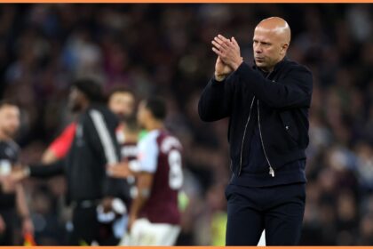 Arne Slot applauds the Liverpool fans at Villa Park