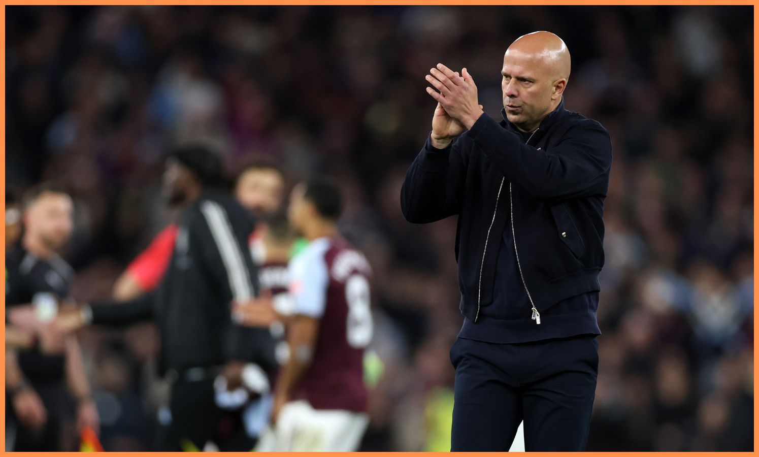 Arne Slot applauds the Liverpool fans at Villa Park
