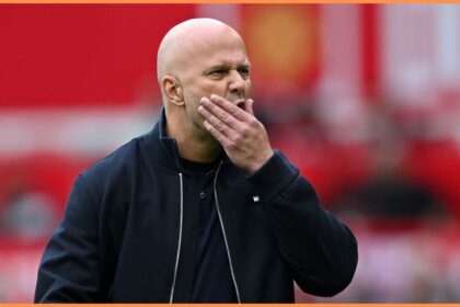 Liverpool head coach Arne Slot rubs his face worriedly.