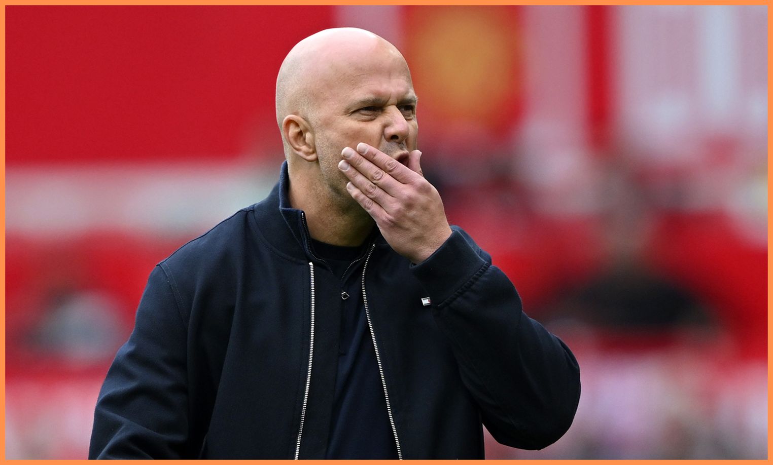 Liverpool head coach Arne Slot rubs his face worriedly.