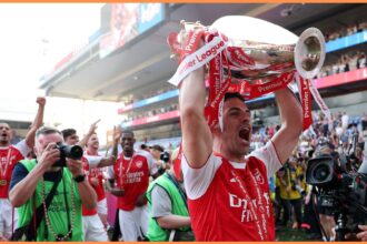 Arsenal manager Mikel Arteta lifts the Premier League trophy