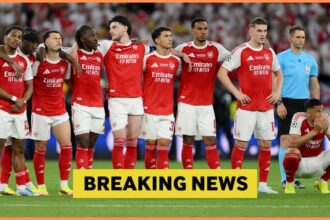Arsenal players watching the penalty shoot-out against PSG