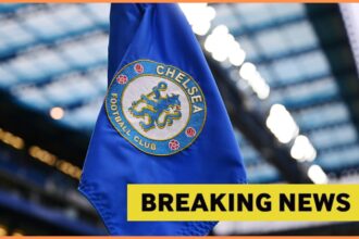 Chelsea logo on corner flag, and breaking news banner