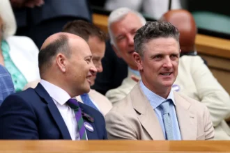 LONDON, ENGLAND - JULY 01: Golfer Justin Rose (R) speaks with writer Sir Keith Ajegbo in the Royal Box on day two of The Championships Wimbledon 2026 at All England Lawn Tennis and Croquet Club on June 30, 2026 in London, England.