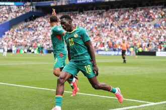 Ismaila Sarr celebrates after scoring vs Belgium