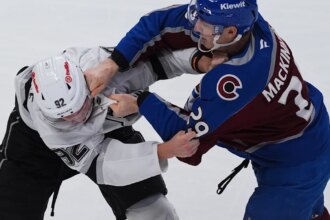 MacKinnon scores two goals and fights in Avalanche's 8-4 season-opening win over Kings